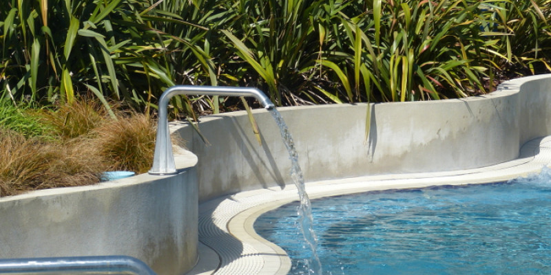 Heated play pool with water spouts