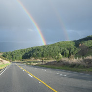 Rainbow spanning the distant road